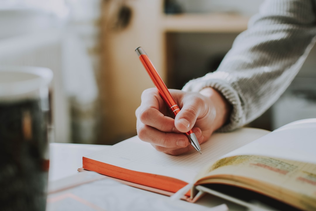 Close-up of a student writing notes by hand while working through a problem