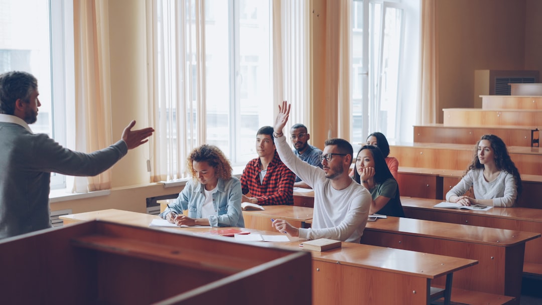 Students raising their hands to answer a question in class