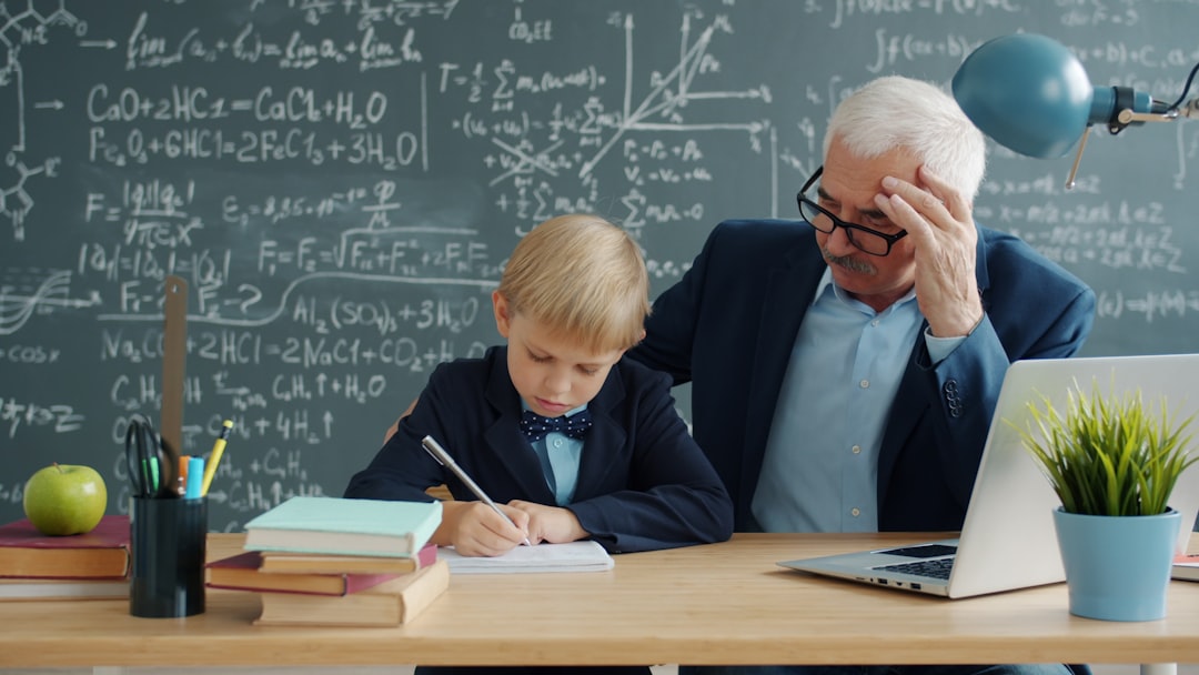 Teacher helping a student work through a problem at a desk